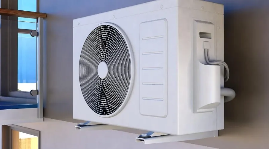 Aircon outdoor unit mounted on a wall bracket outside a building