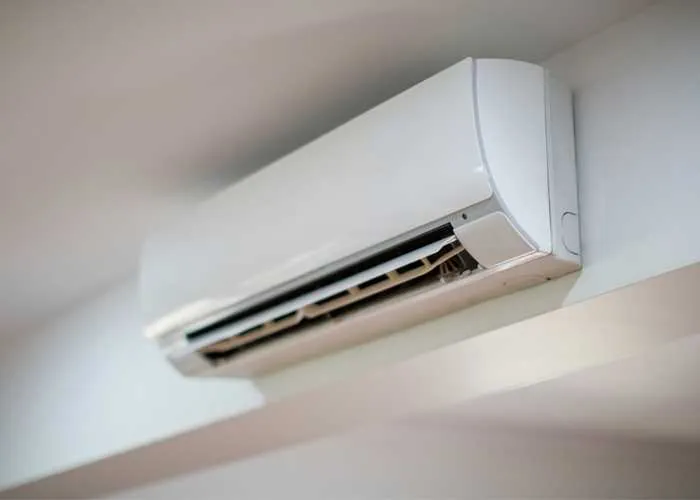 Close-up of a white wall split aircon with the louvre open